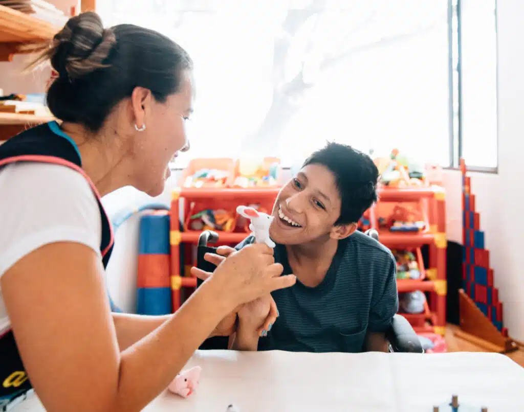 In the image, you see a child with cerebral palsy working with a doctor or therapist